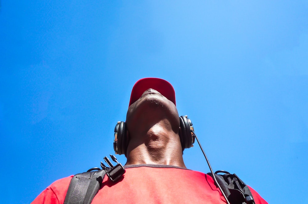 man looking up while wearing black headphones