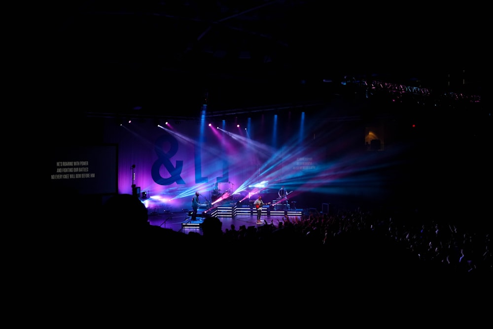 man standing in front of crowd during nighttime