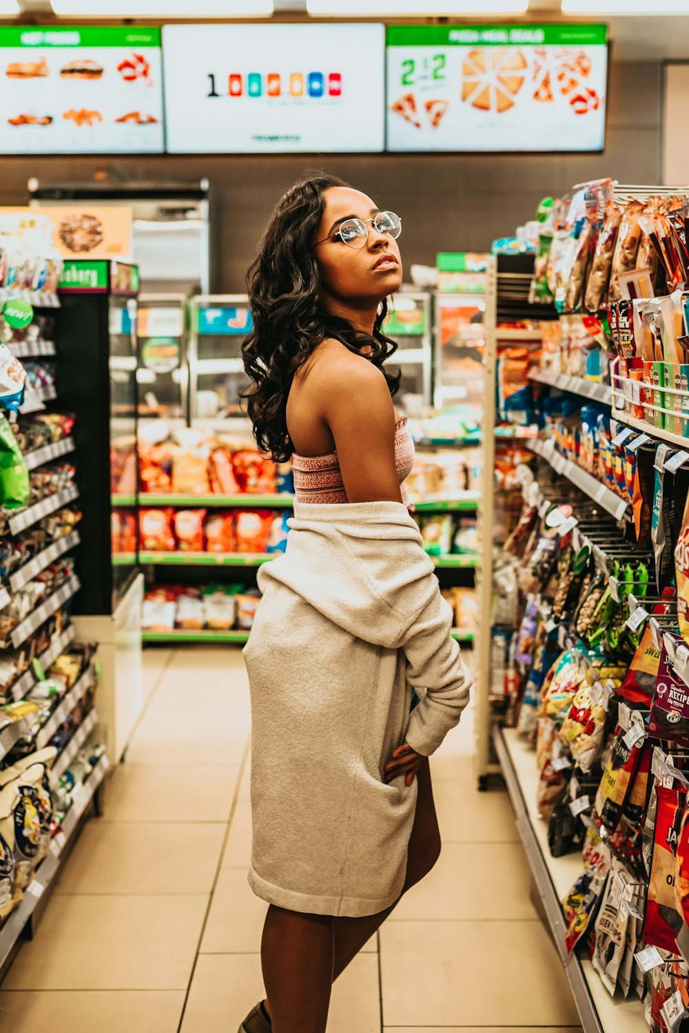 woman in front of snacks lane inside store