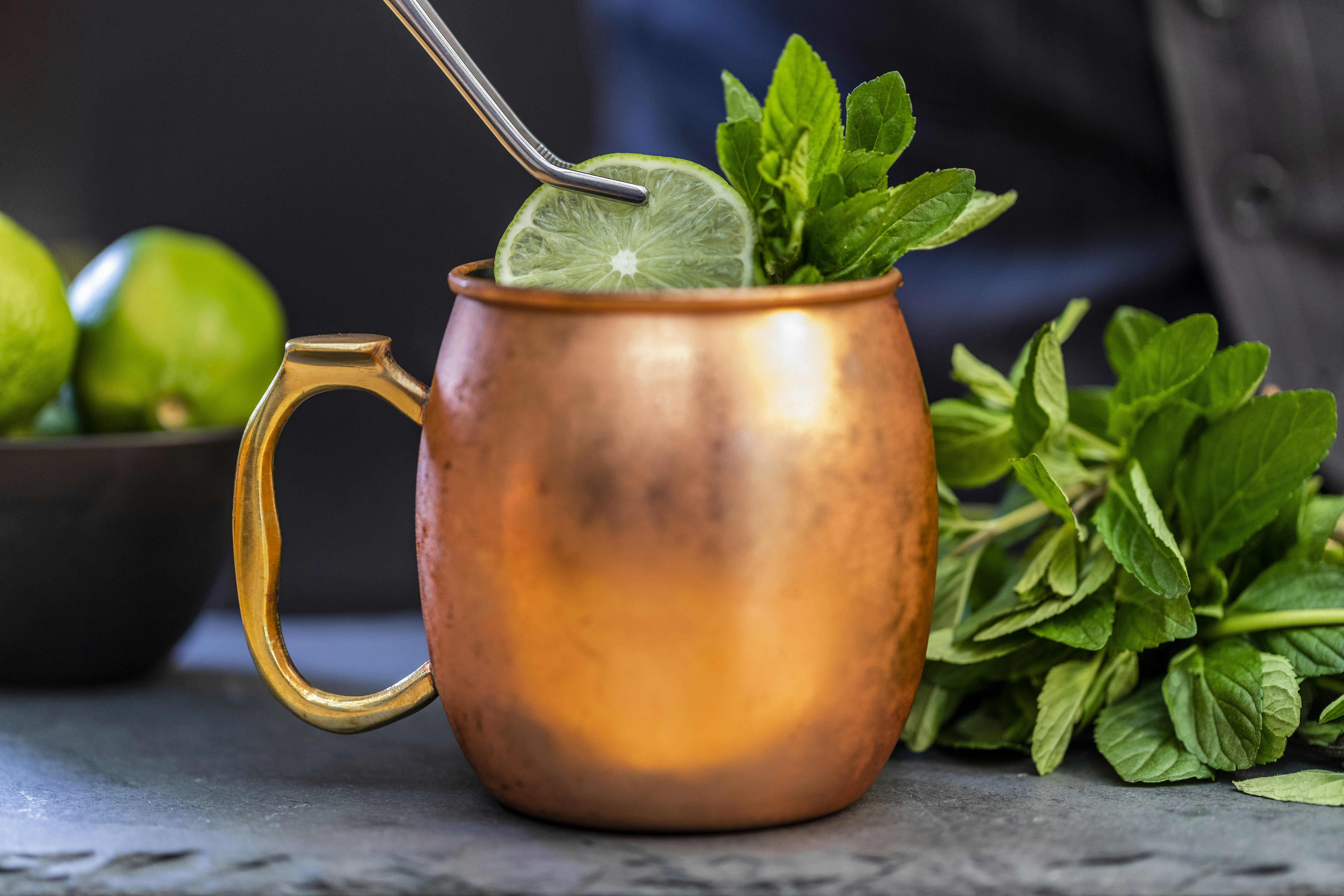 brass-colored mug with sliced lime