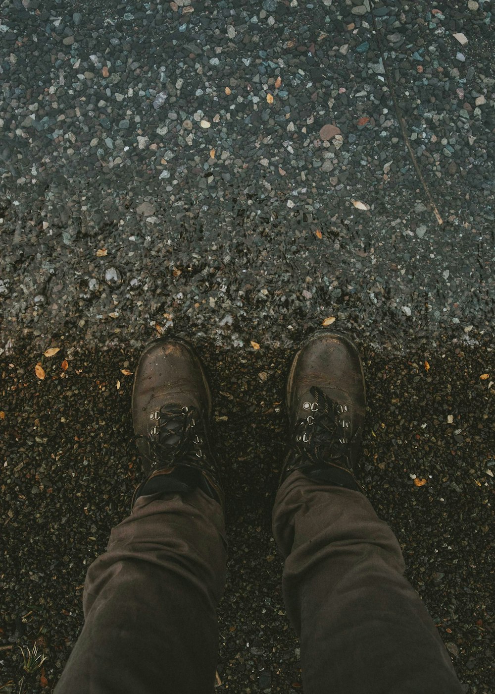 Persona con botas de cuero negro de pie en el suelo