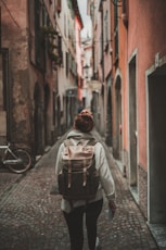 woman walking on street surrounded by buildings