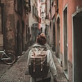 woman walking on street surrounded by buildings