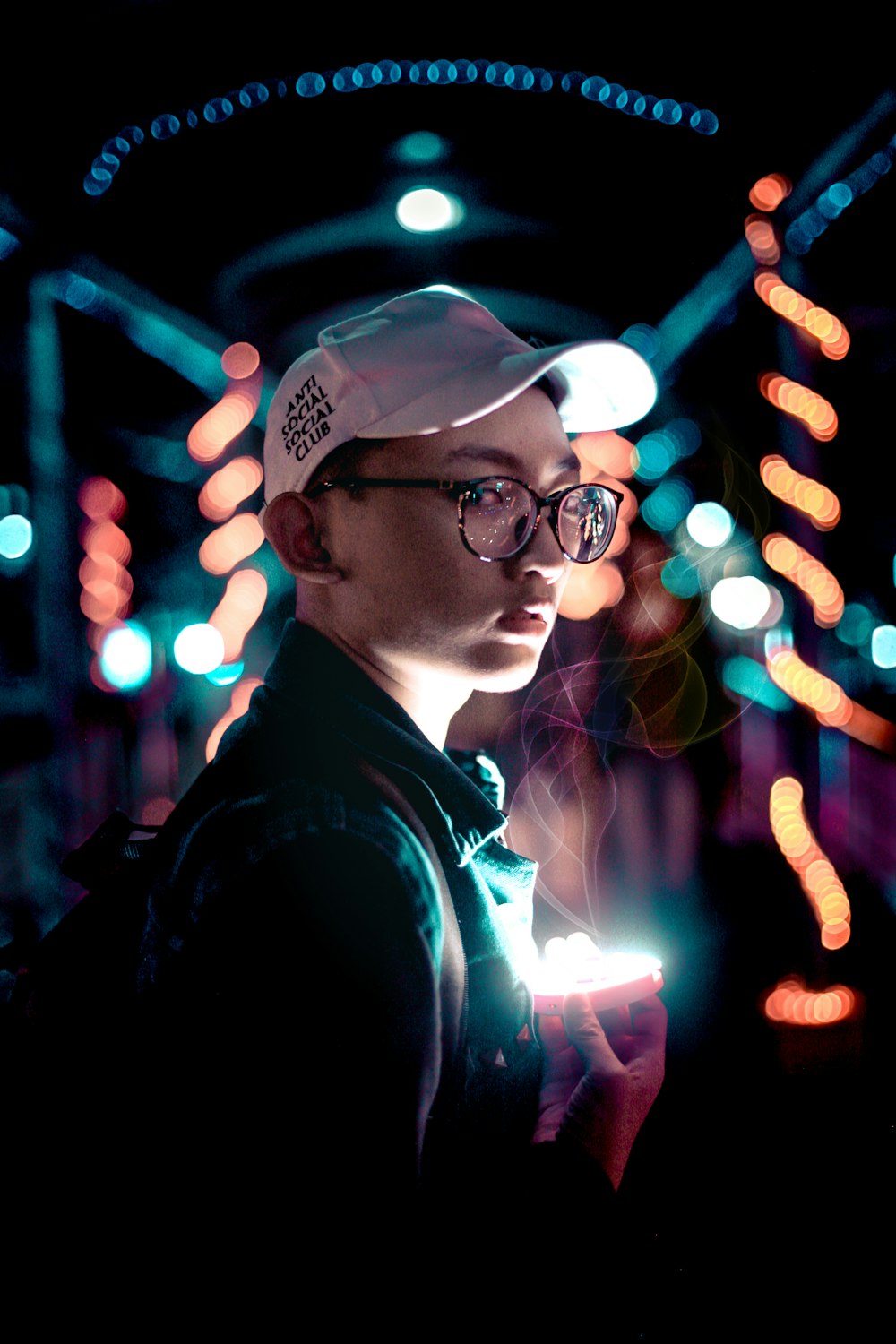 shallow focus photography of person holding light