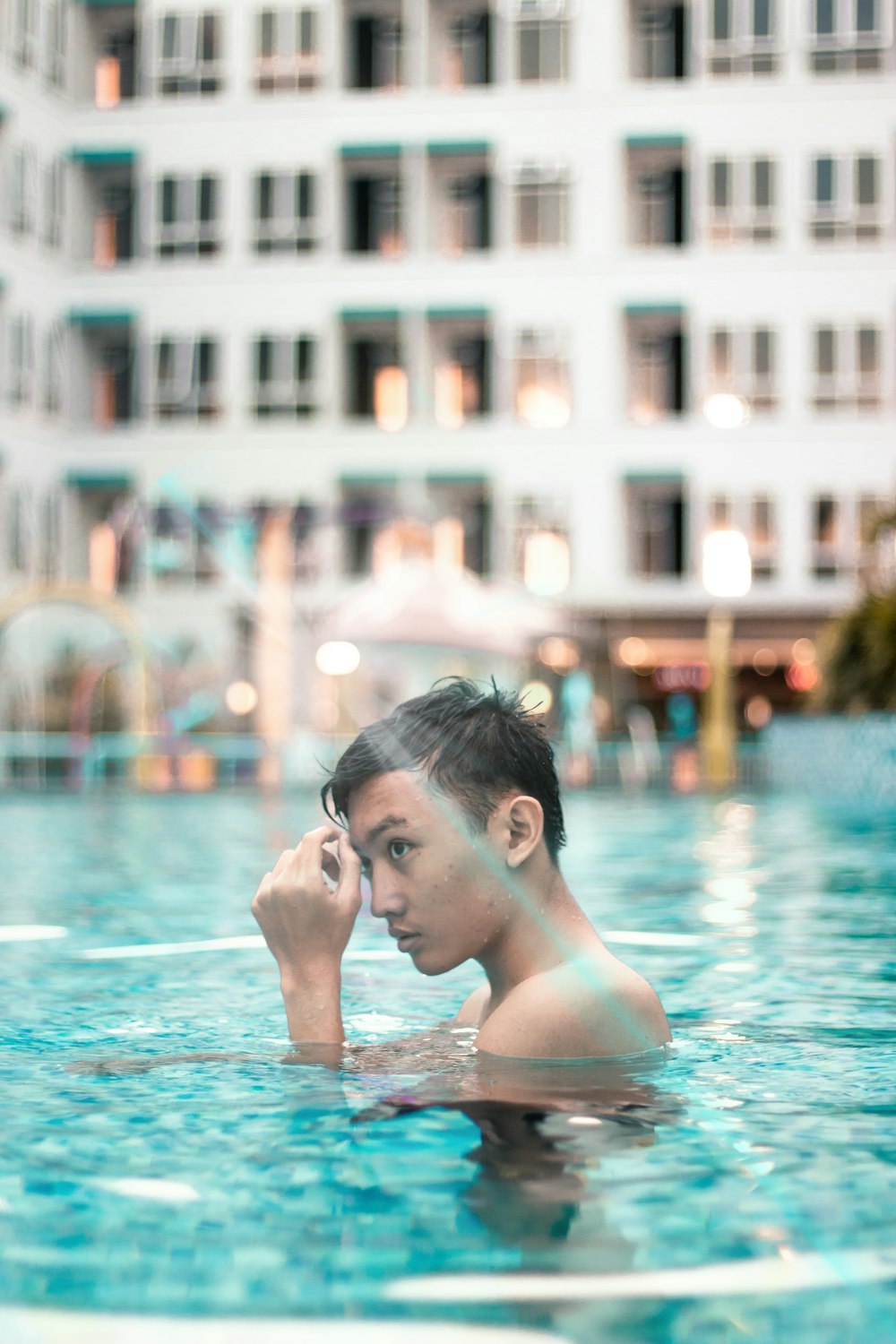 close-up photo of man bathing on swimming pool