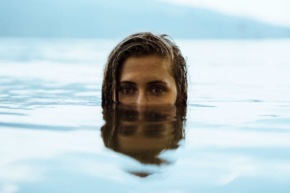 mujer en el cuerpo de agua durante el día