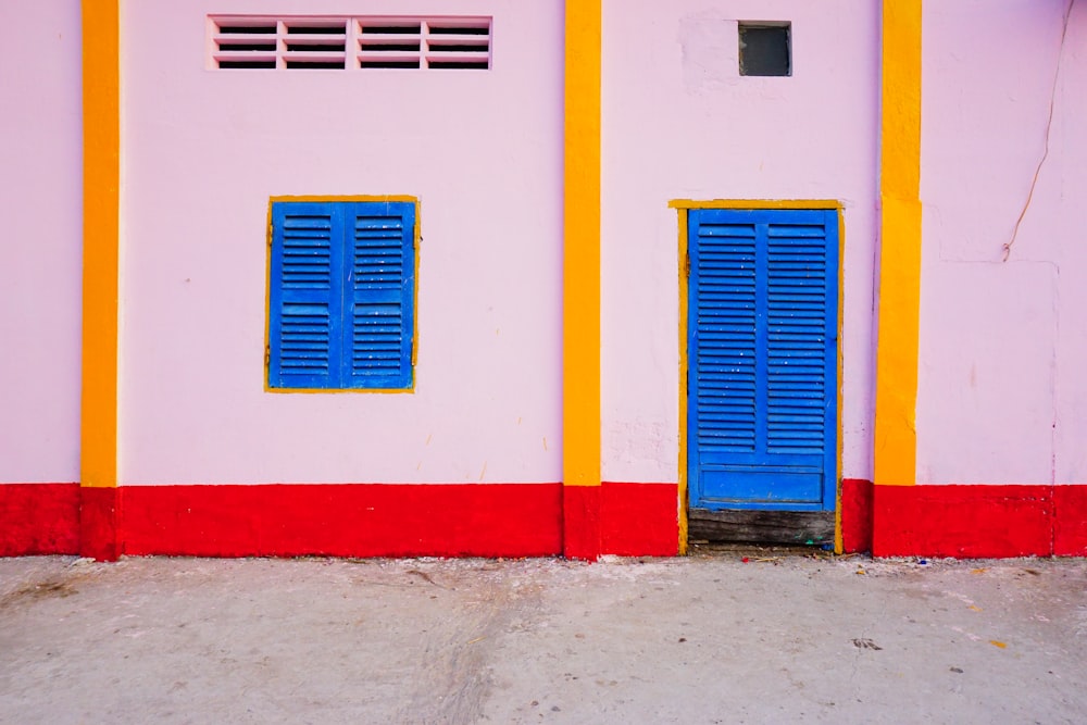 closed blue wooden louvered door ahead