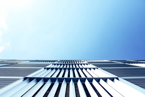 An artistic aerial perspective of a modern architectural complex, showcasing clean lines and geometric shapes.