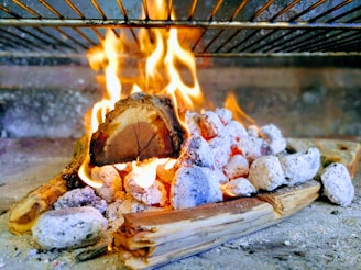 Warm, inviting scene of a barbecue gathering with glowing embers and rich textures