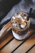 shallow focus photo of brown liquid in clear drinking glass
