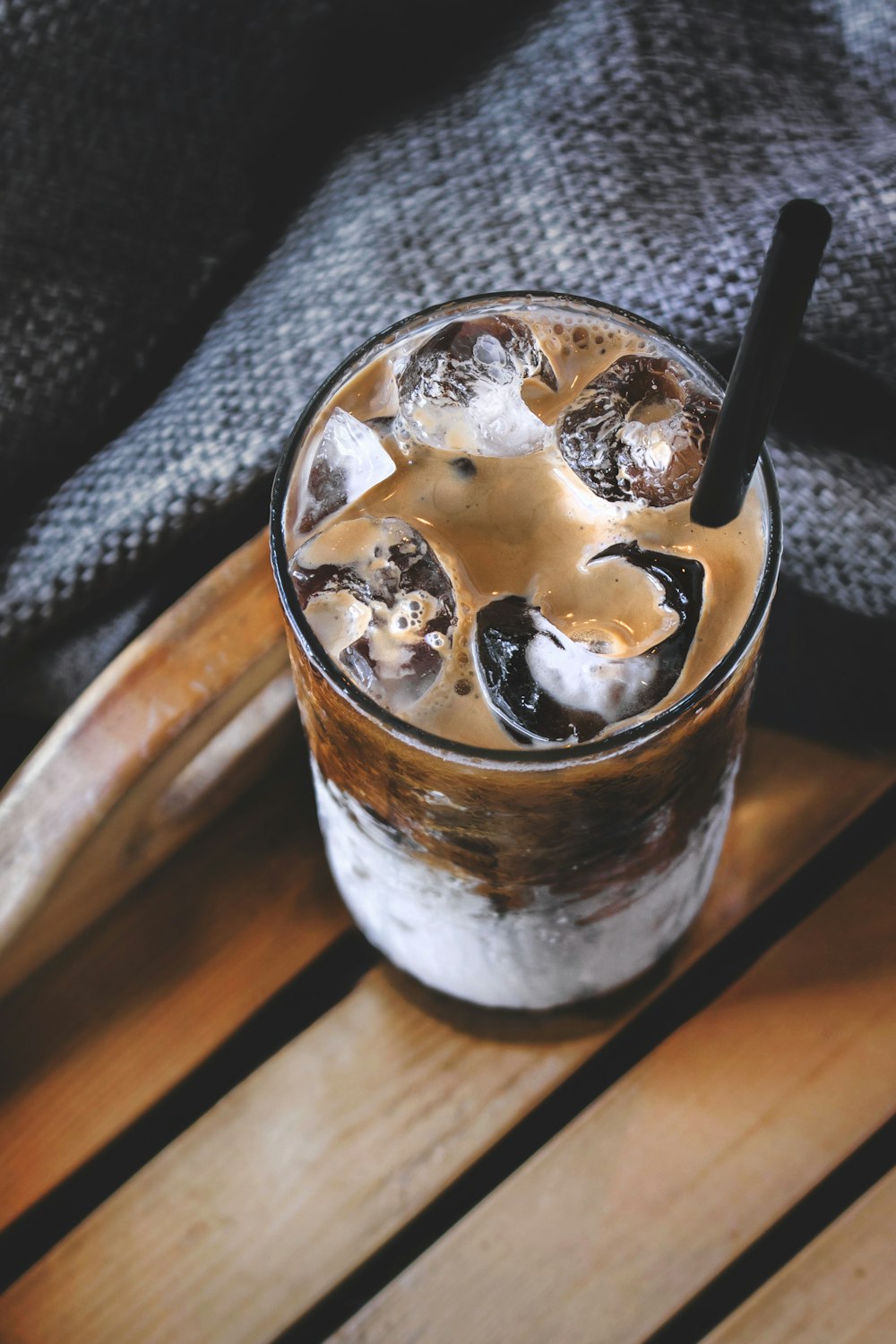 shallow focus photo of brown liquid in clear drinking glass