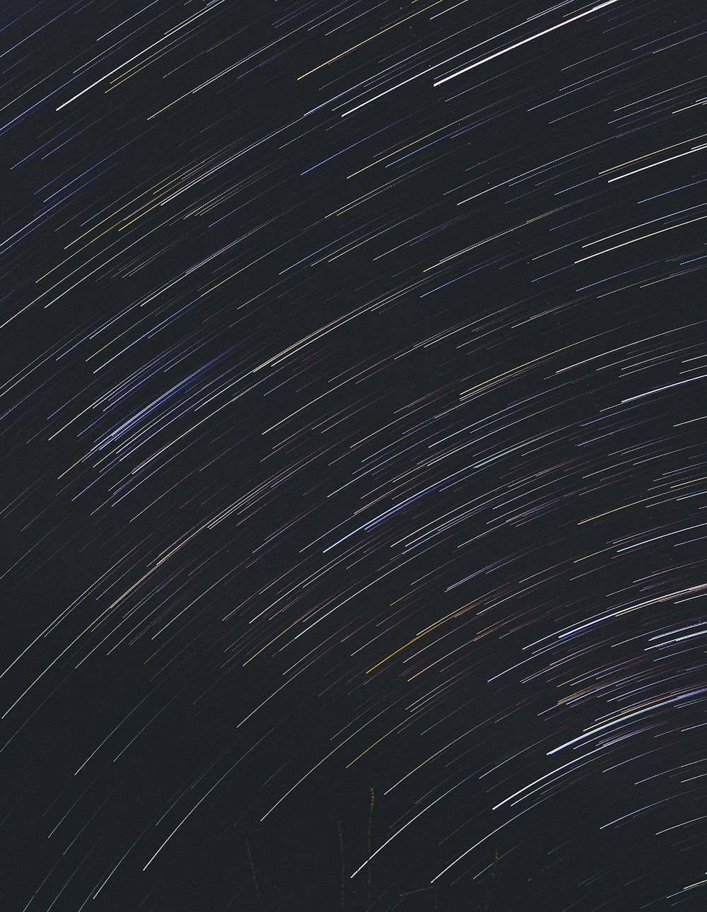 the night sky is filled with star trails