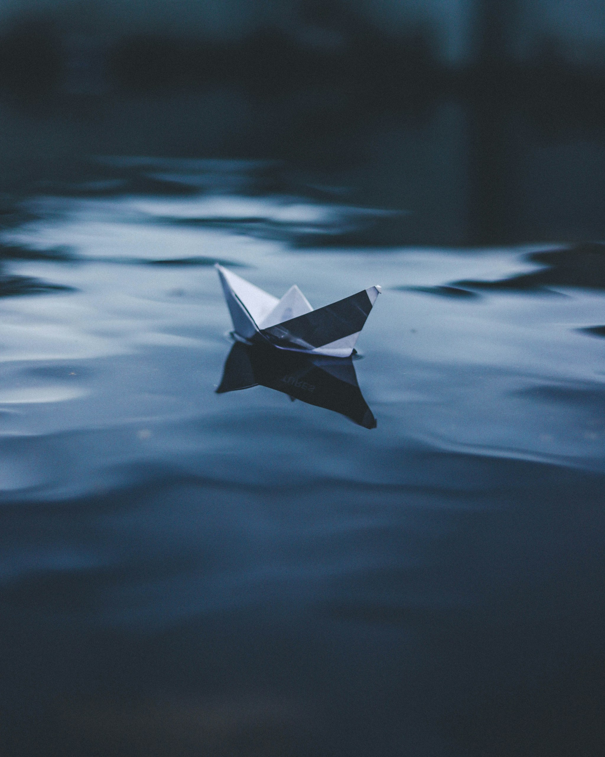 paper boat on body of water