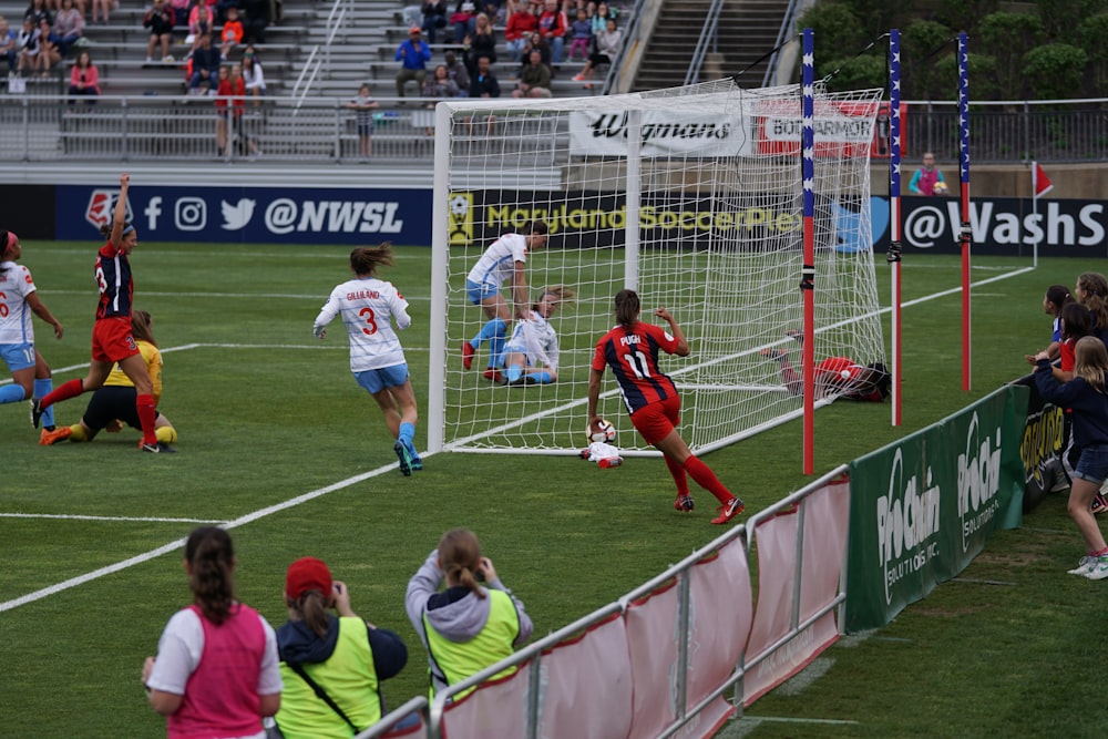 soccer players in field during daytime