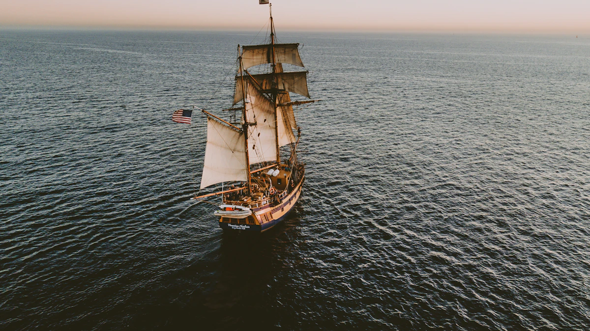 A large square-rigged sailing ship silhouetted against the sky