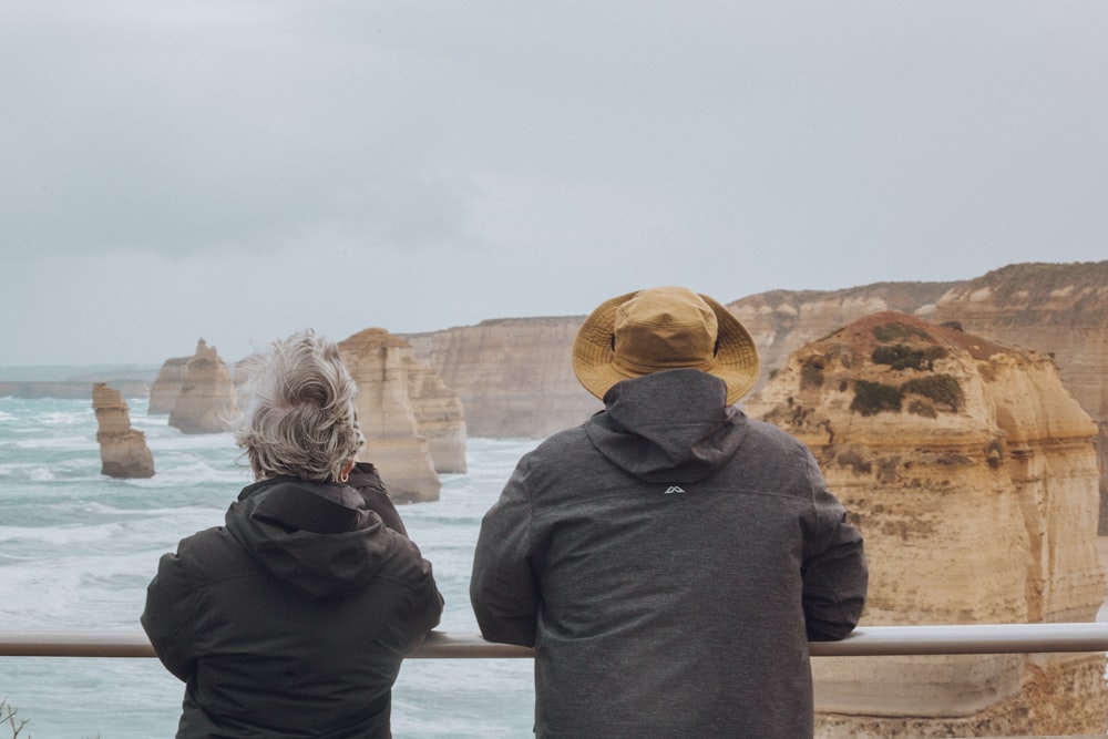 two person standing in front of formation rocks