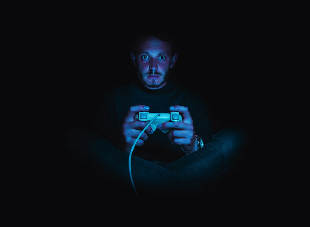 man holding corded game controller