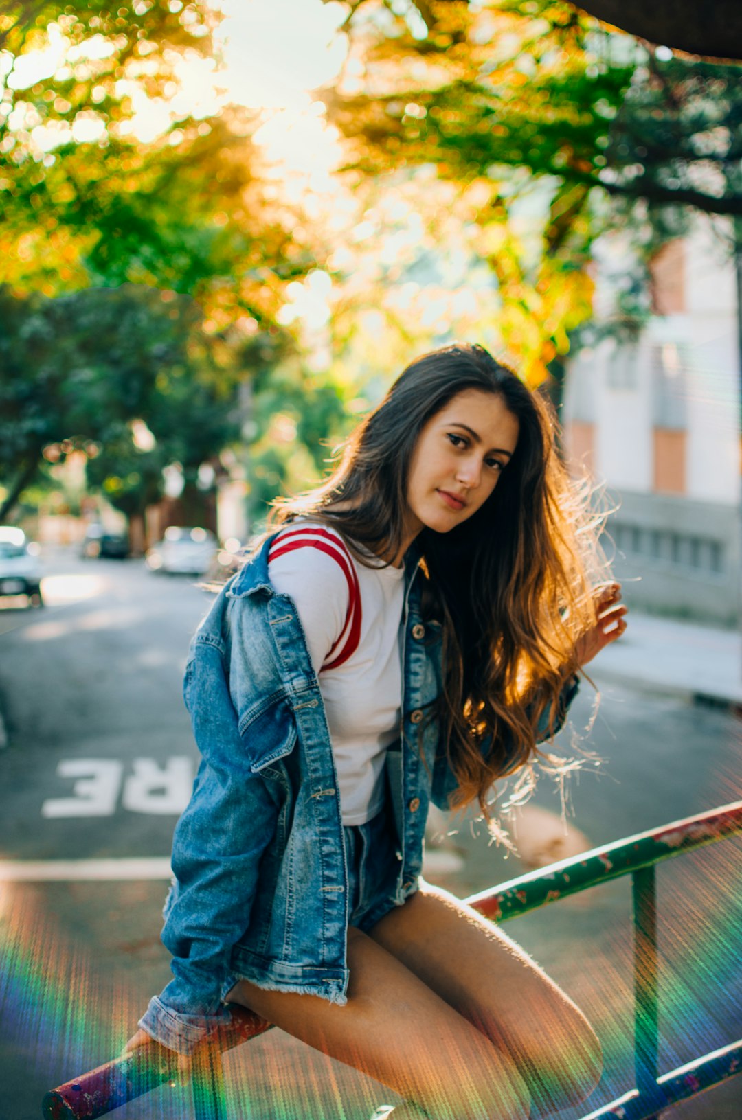 woman sitting on metal railings