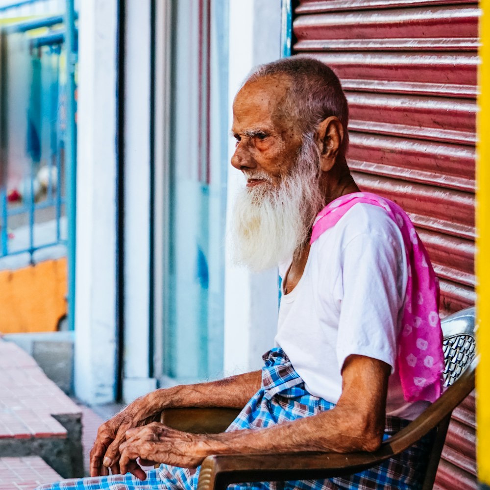 man sitting on armchair during daytime