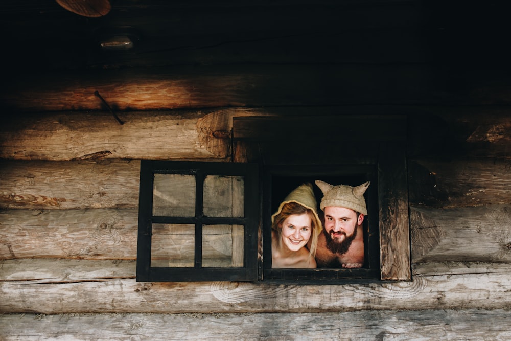 man and woman peeking on window