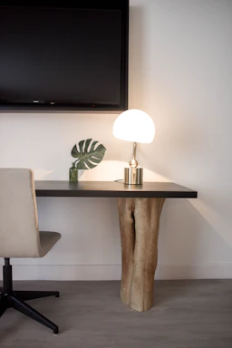 Elegant workspace with a minimalist handcrafted console table bathed in soft natural light.