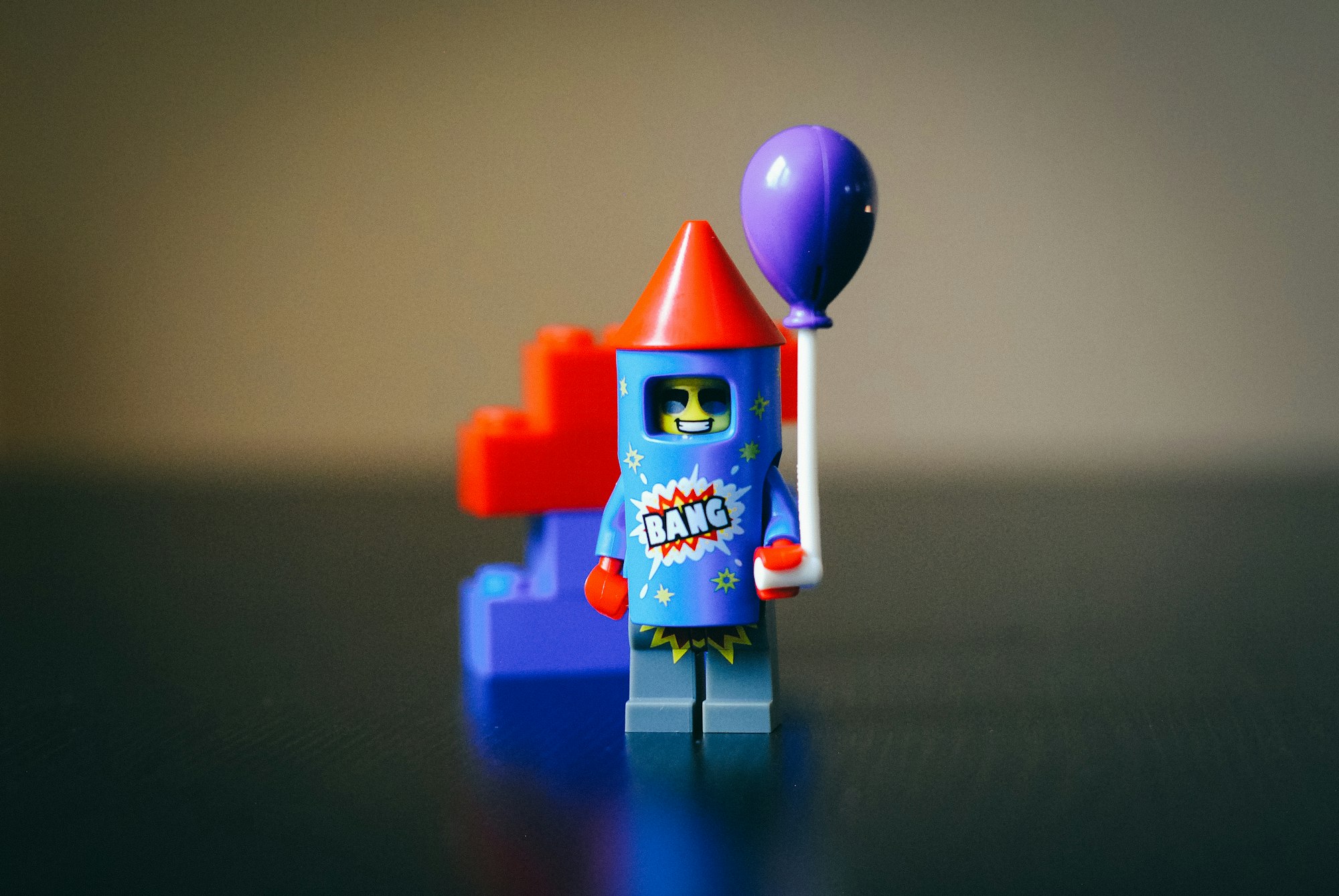 A LEGO minifigure, wearing a firework costume, which reads "BANG".
