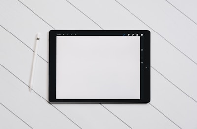Minimalist illustration of a tablet displaying an interactive learning app interface.