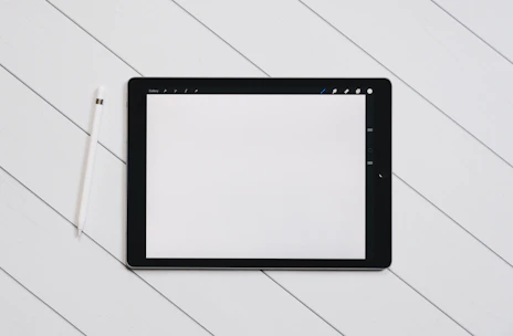 Close-up of hands working on a website layout on a tablet with minimalistic design.
