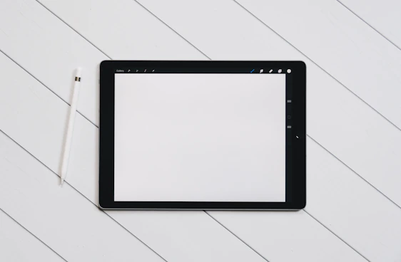 A clean, minimalist illustration of a tradesperson using a tablet on-site with a simple navy blue and white colour scheme.