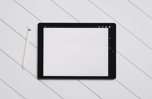 Close-up of a minimalist product design wireframe on a digital tablet with soft shadows