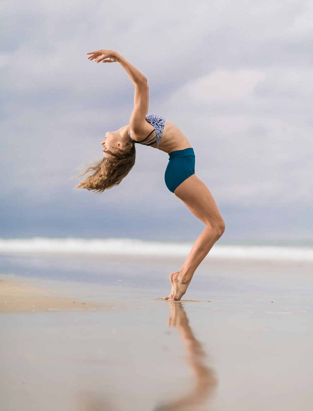 woman standing on seashore during daytime