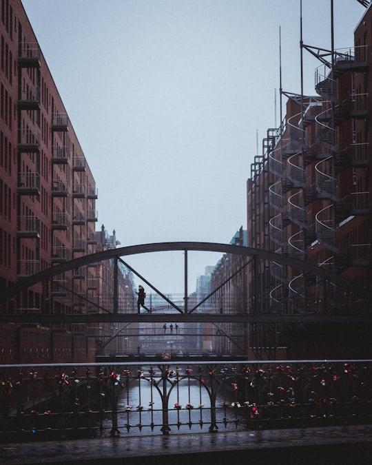 person walking on bridge in Speicherstadtmuseum Germany