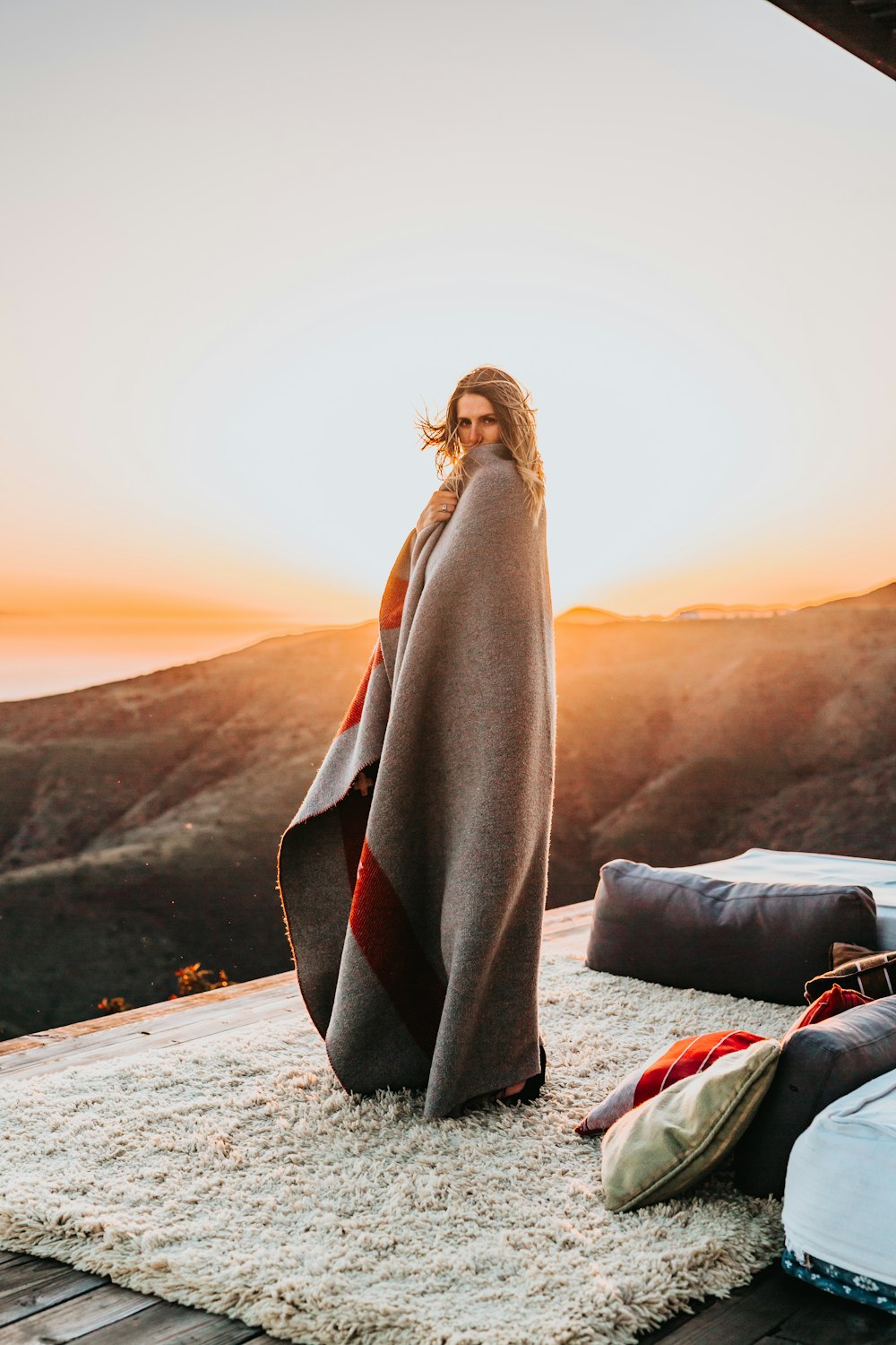 woman covered by gray comforter