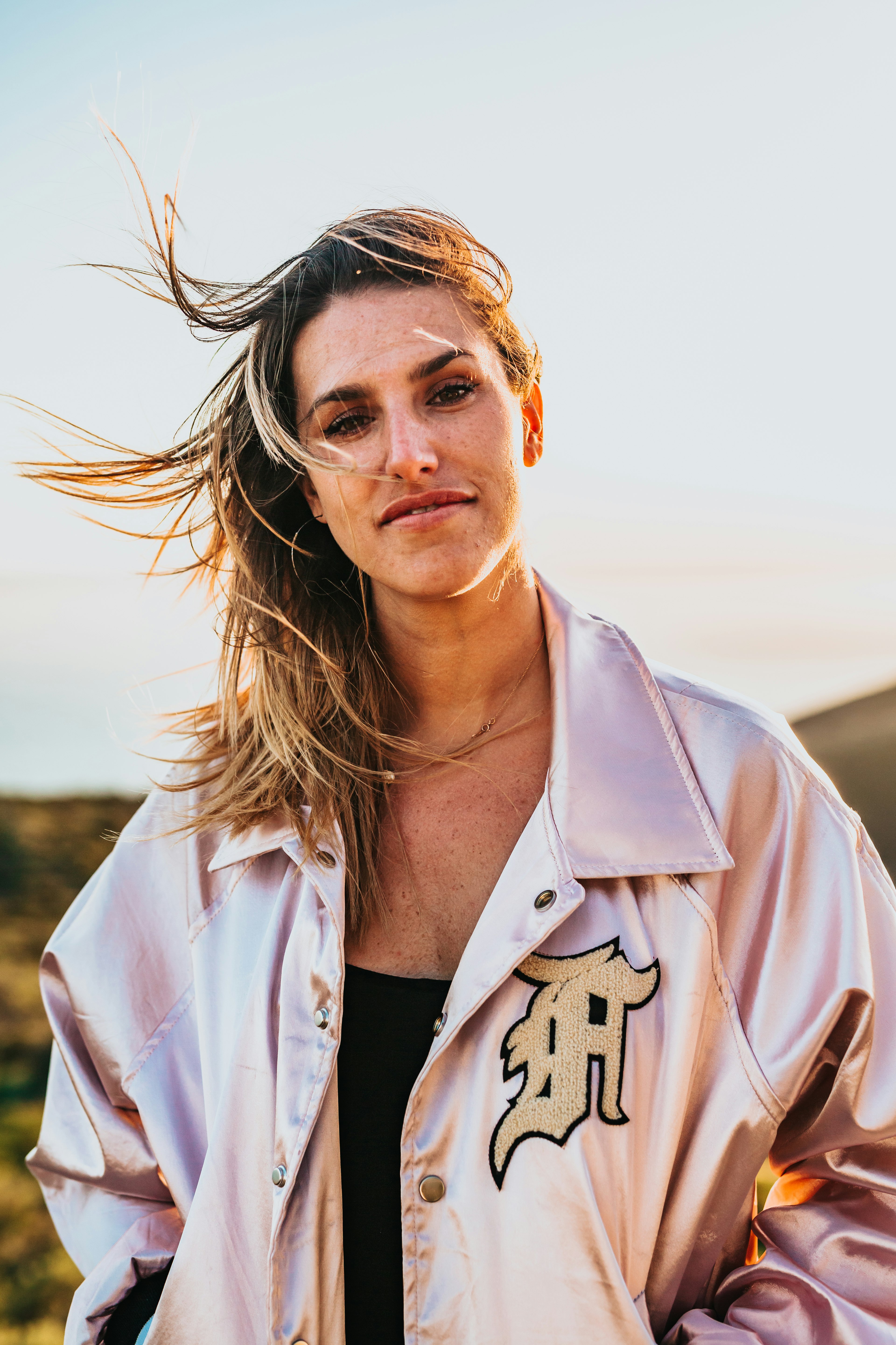 woman wearing white bomber jacket