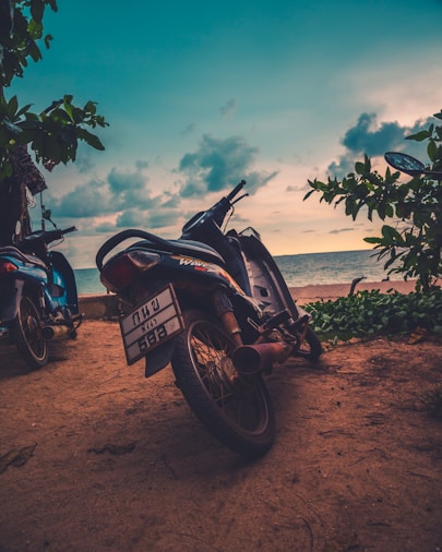 two black motorcycles near ocean