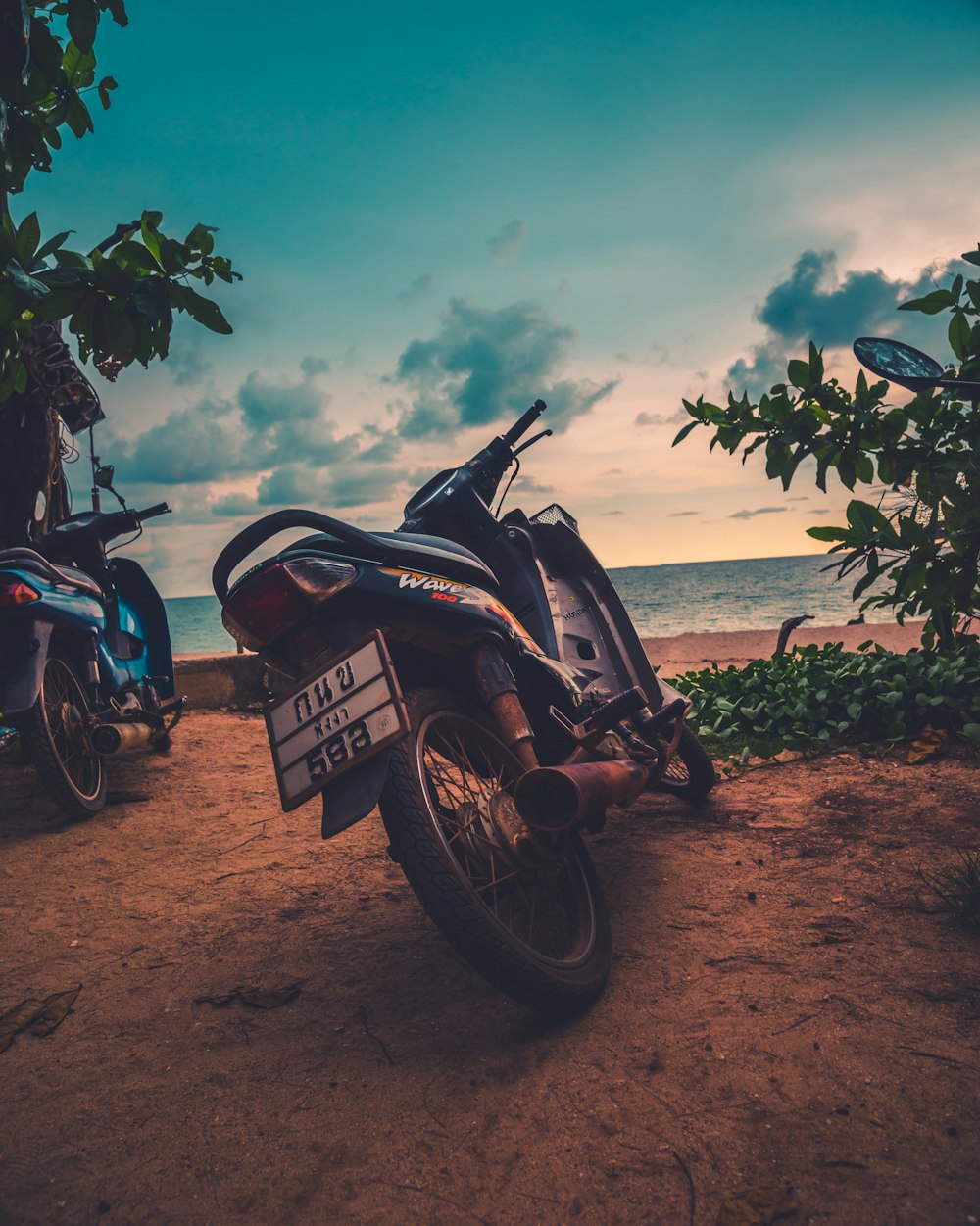 two black motorcycles near ocean