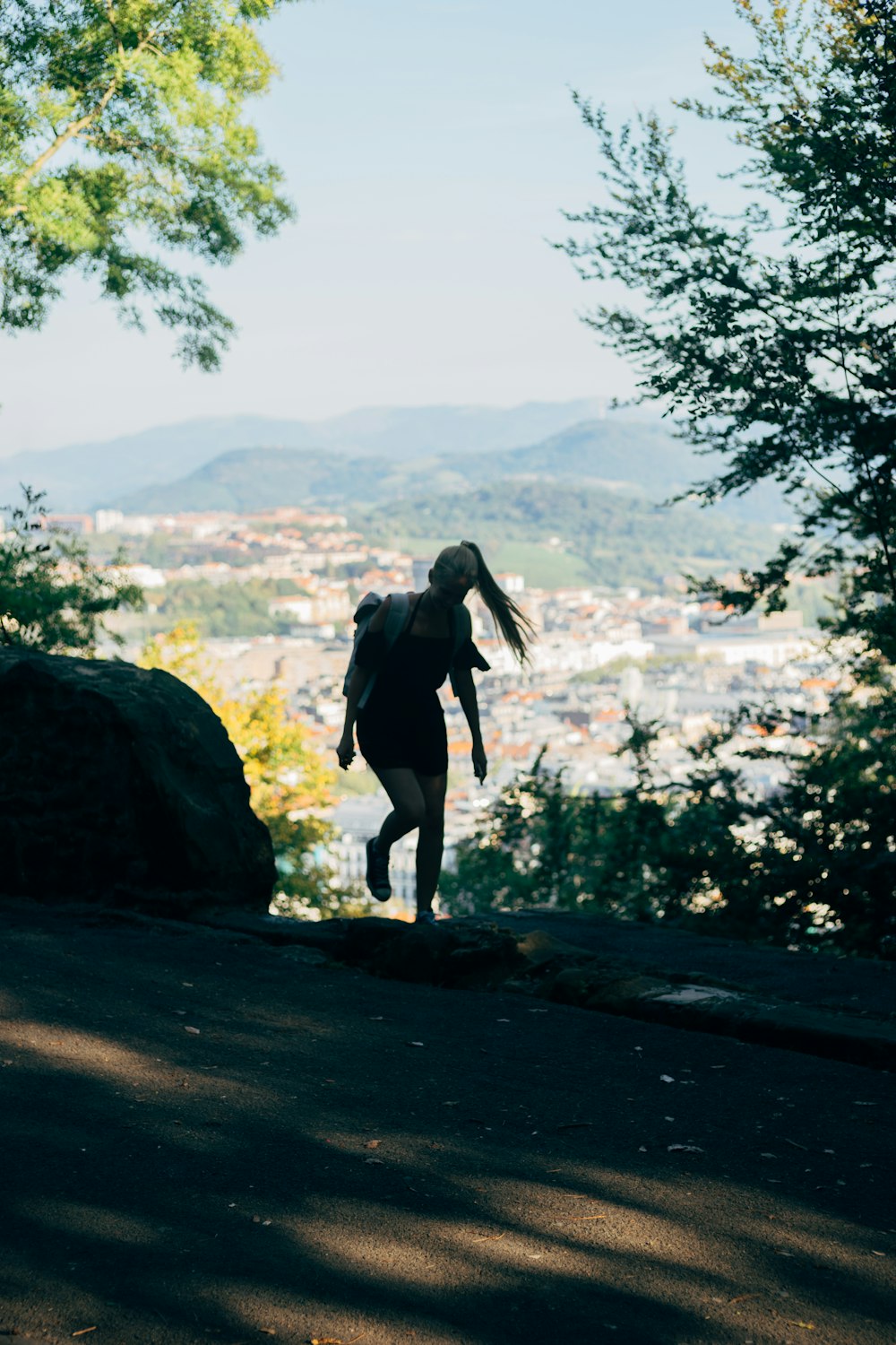 a person with a backpack walking up a hill