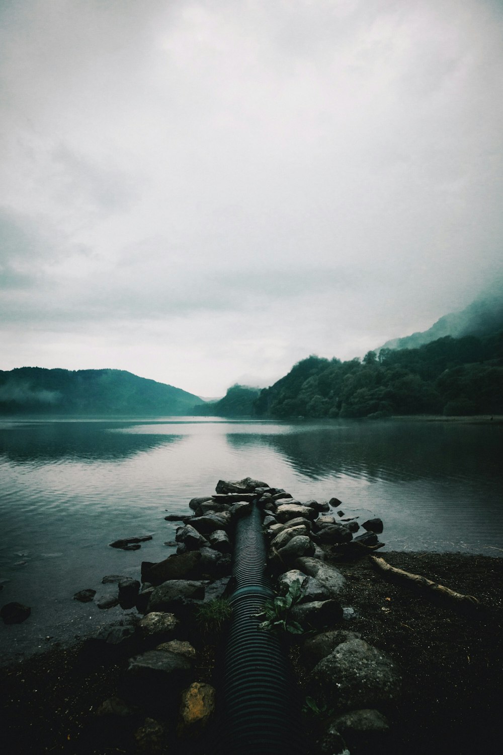 stone fragment beside body of water during daytime