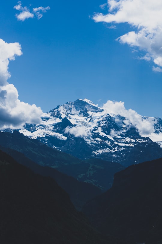 snow-covered mountain under white clouds during daytime in Interlaken Switzerland