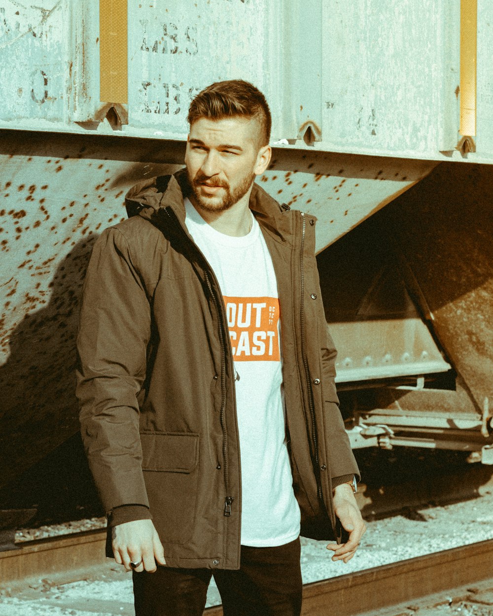 man standing in front of gray wall