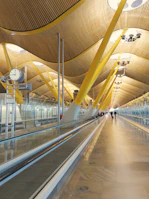 A corporate travel scene with professionals walking through a modern airport terminal.