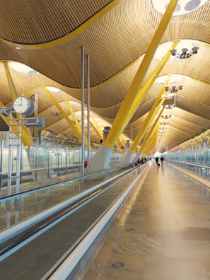 A corporate travel scene with professionals walking through a modern airport terminal.