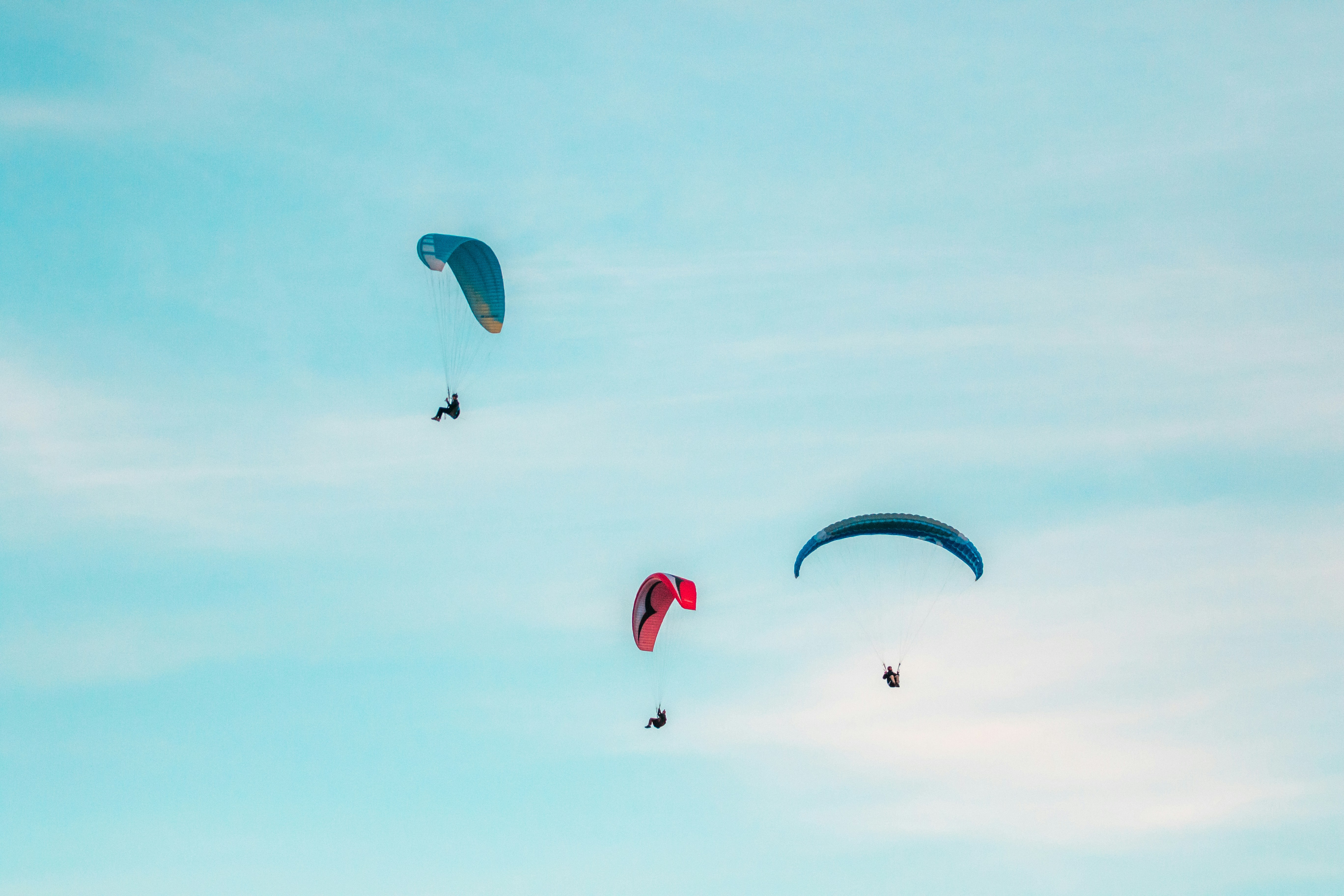 three person midair with parachutes, Patrick Hendry - The 3 Paragliders
