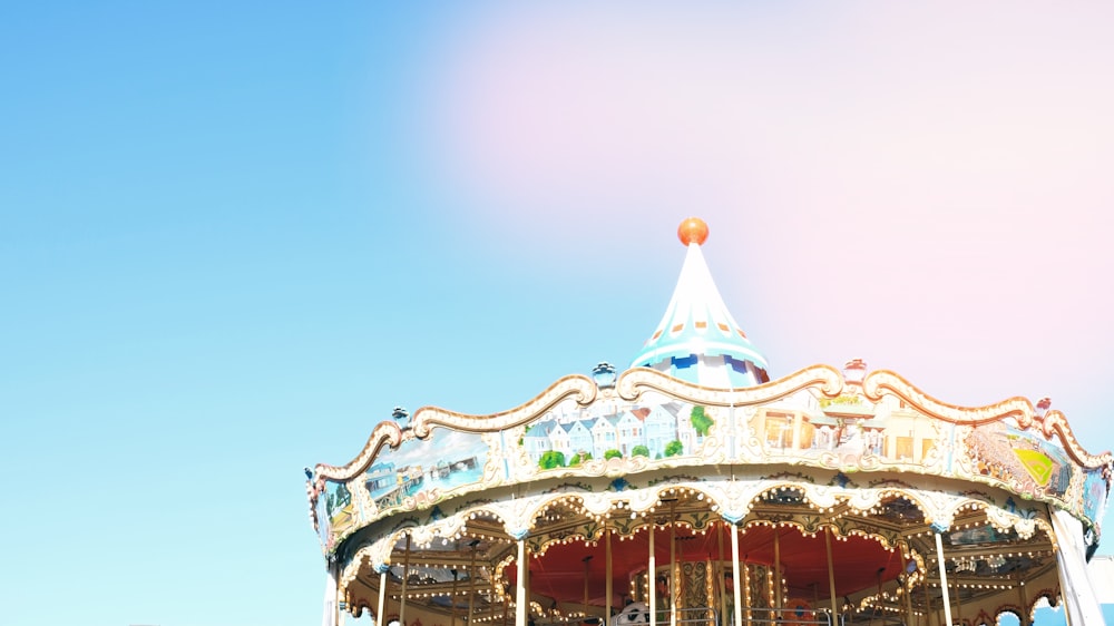 white and multicolored horse carousel at daytime