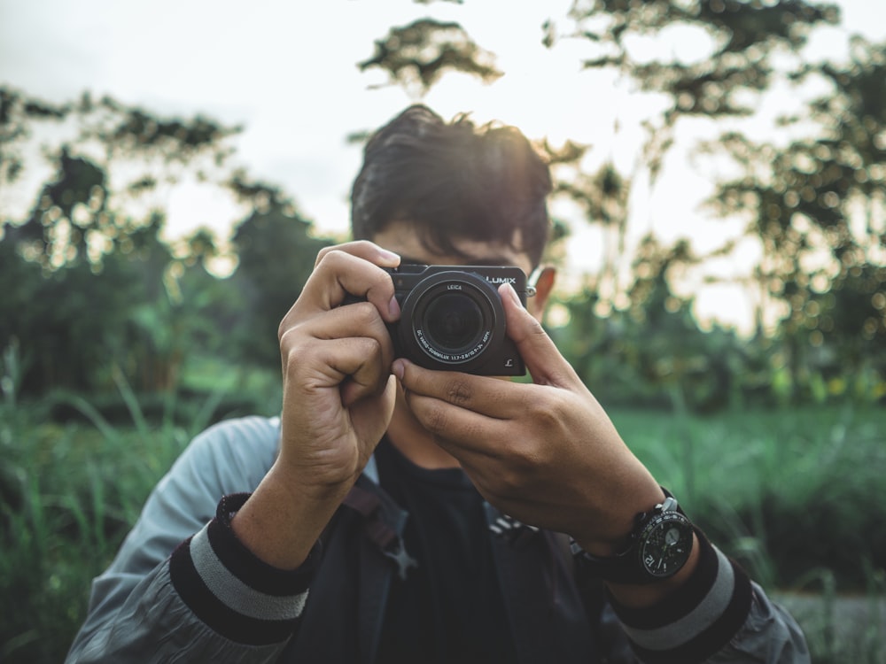 man holding a black camera