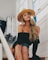 woman in black off-shoulder shirt sitting on brown wooden stairs
