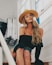 woman in black off-shoulder shirt sitting on brown wooden stairs