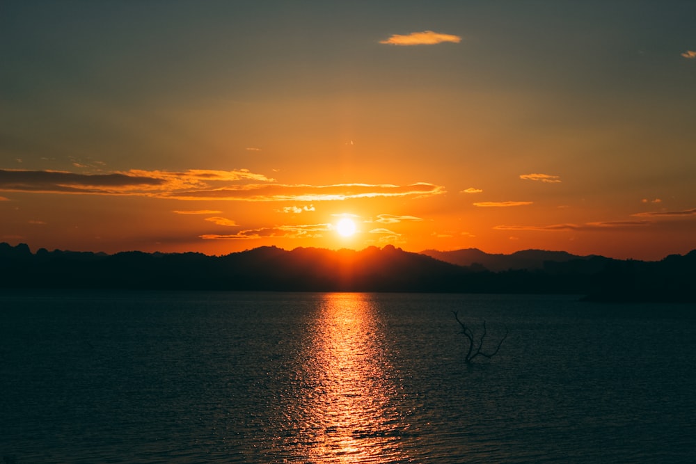 sunset above body of water