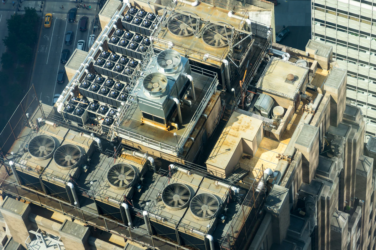 Rooftop chillers and cooling tower fans on a city building in the UAE