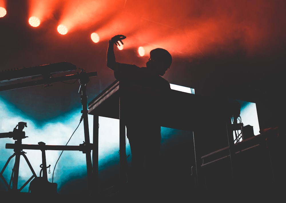 a man standing in front of a stage holding a microphone